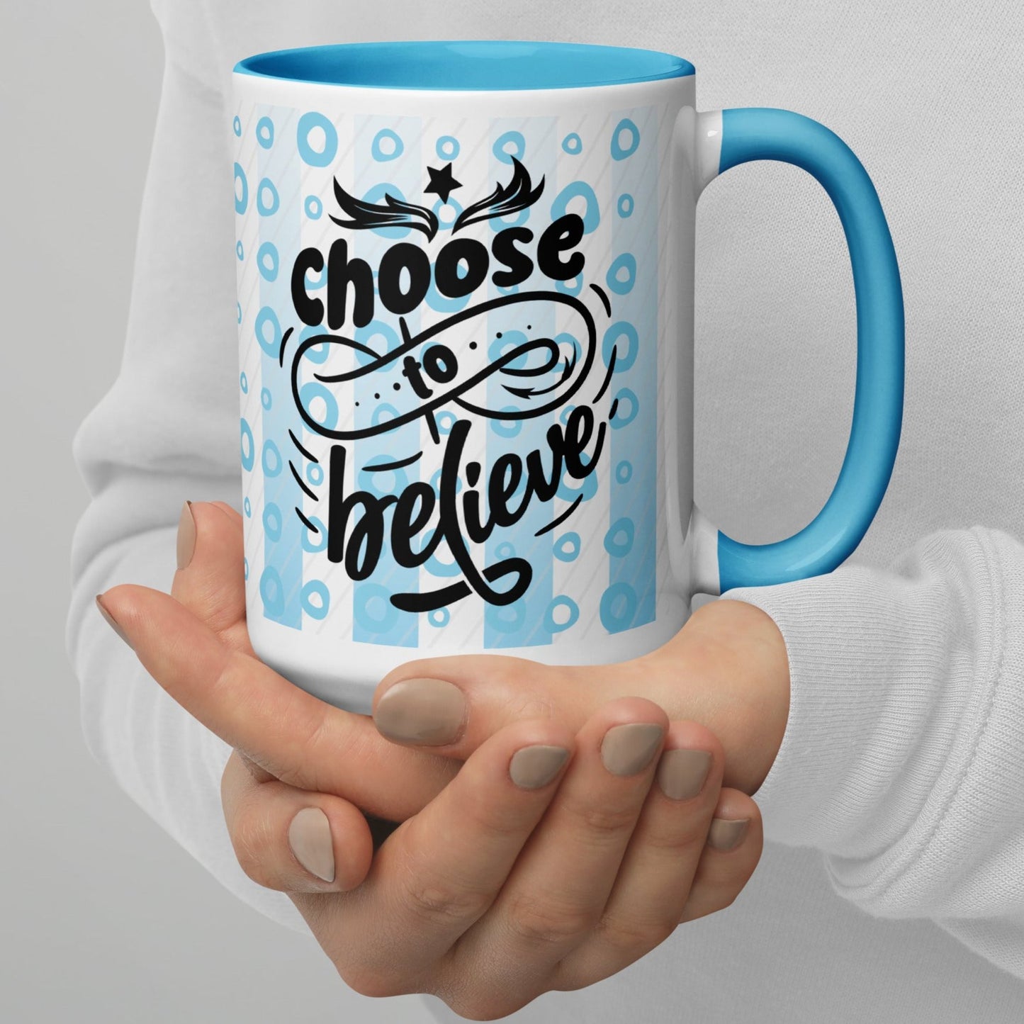 Right view of a white mug with light blue inside and outside in light blue and white lines and circle background, and black text saying 'choose to believe'