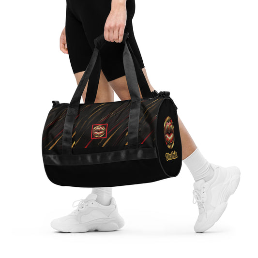 Front of a gym bag with icon of gold, black, and red lips on black patterned background