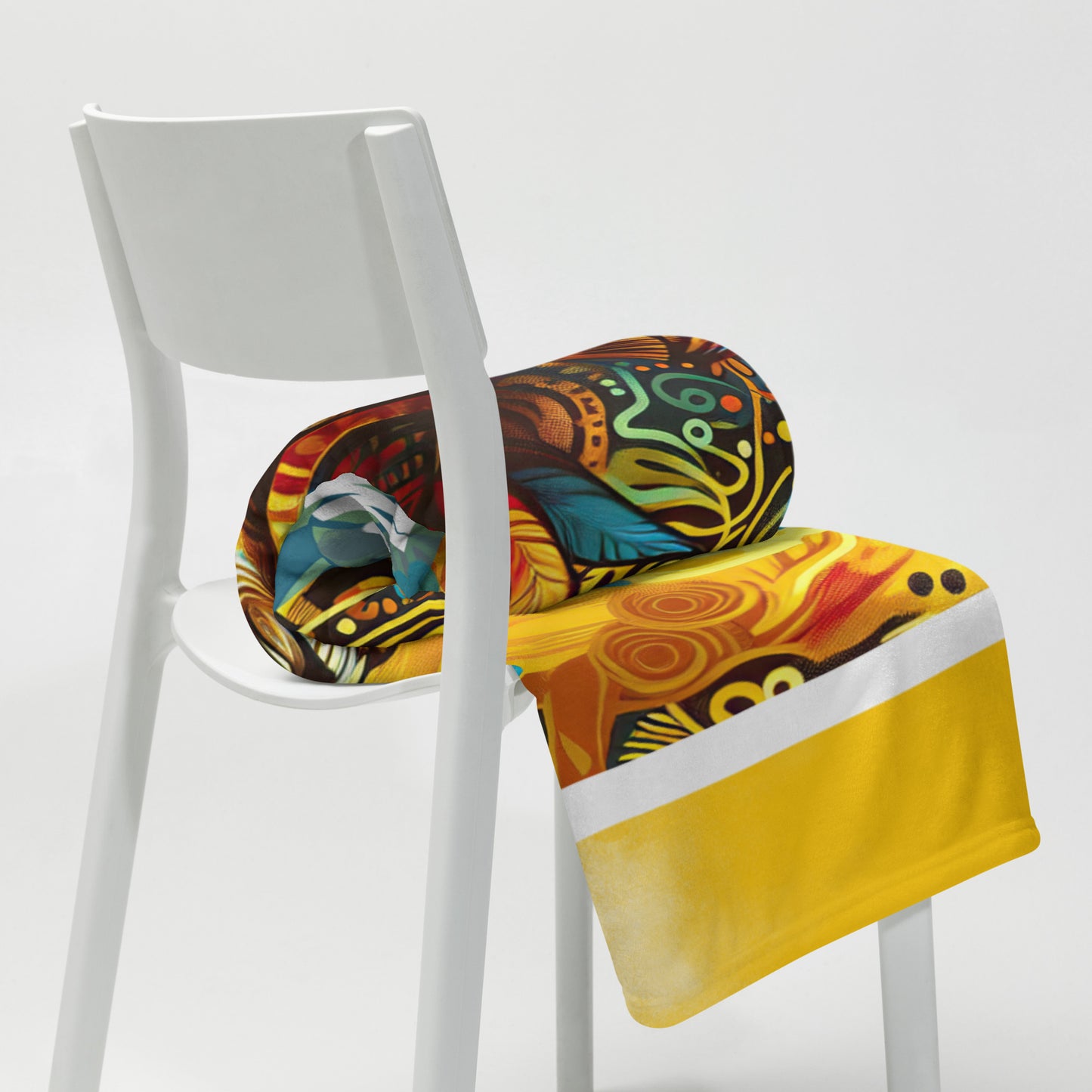 Rolled fearfully, wonderfully made 50 x 60 throw in a white chair