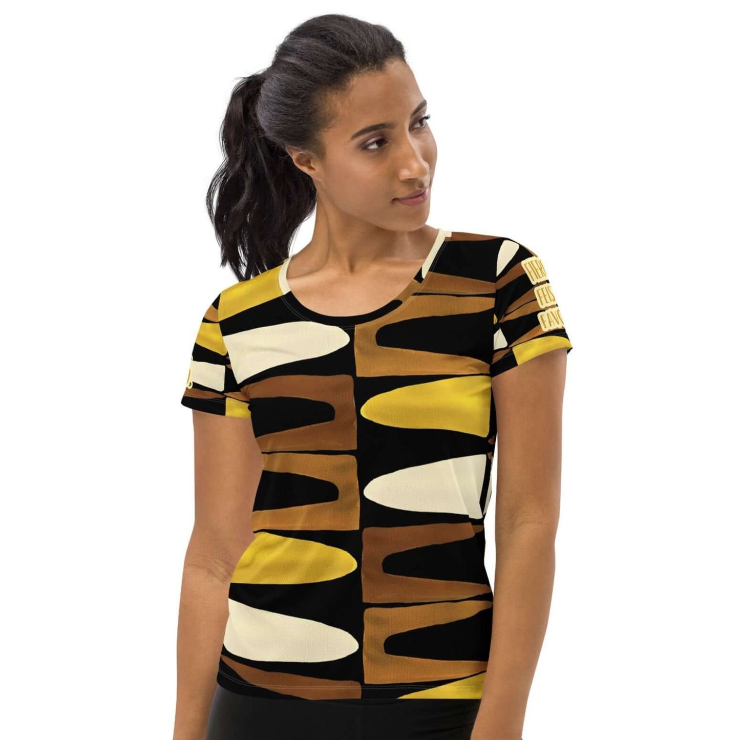 Front view of a woman wearing black, brown, beige and gold print t-shirt with gold and white text saying 'Fierce.Feisty.Favored.' on left and right sleeves