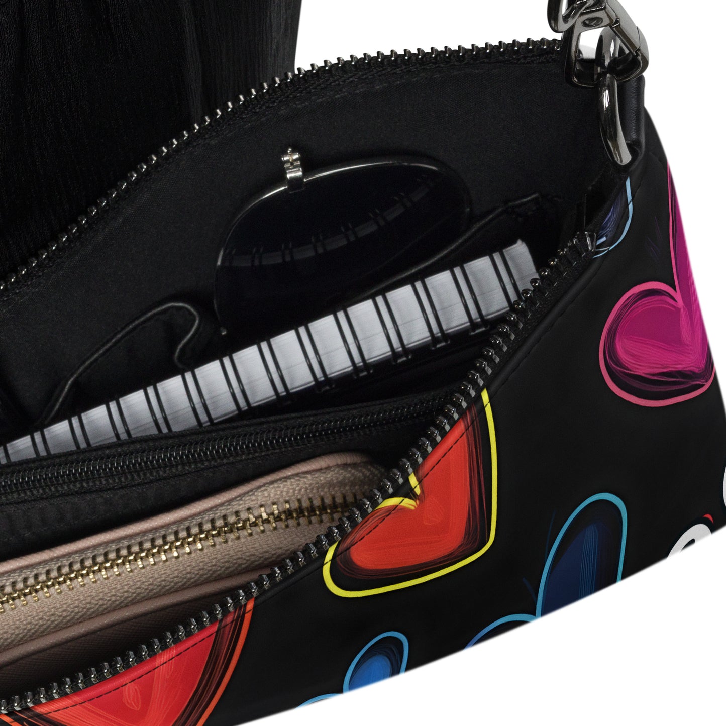 Inside of crossbody bag with hearts on black background