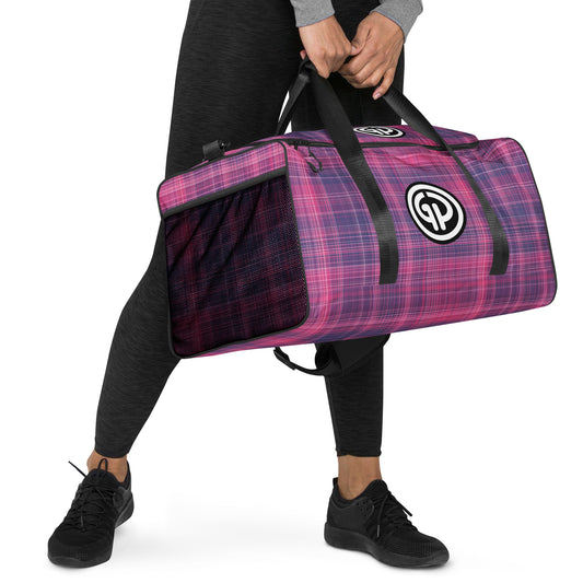 Right front of God's Property duffel bag with purple and fuchsia plaid print and GP logo being carried