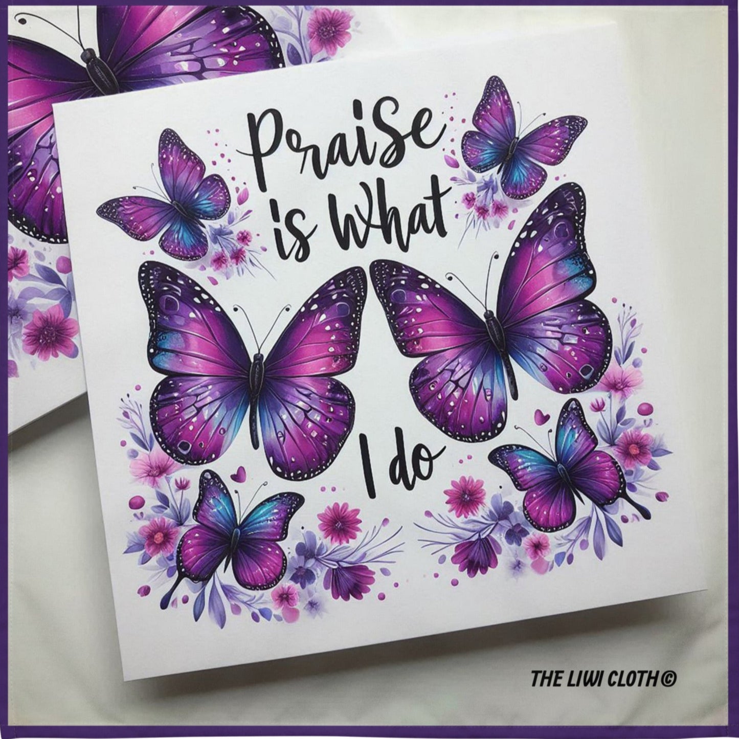 Front of LIWI cloth with purple butterflies and black text saying 'praise is what I do' on a white background