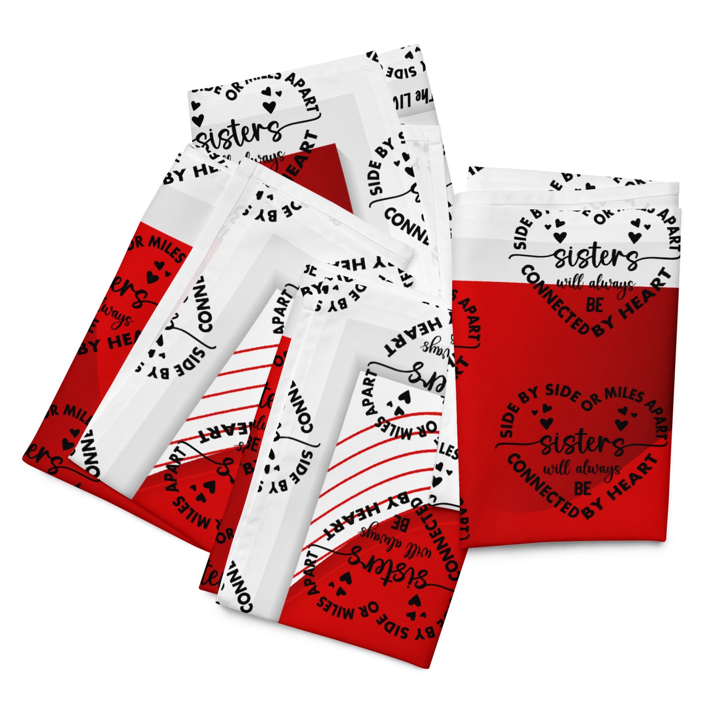 Front of 4 folded red and white Sisters LIWI cloth with icon saying 'Sisters will always be'
