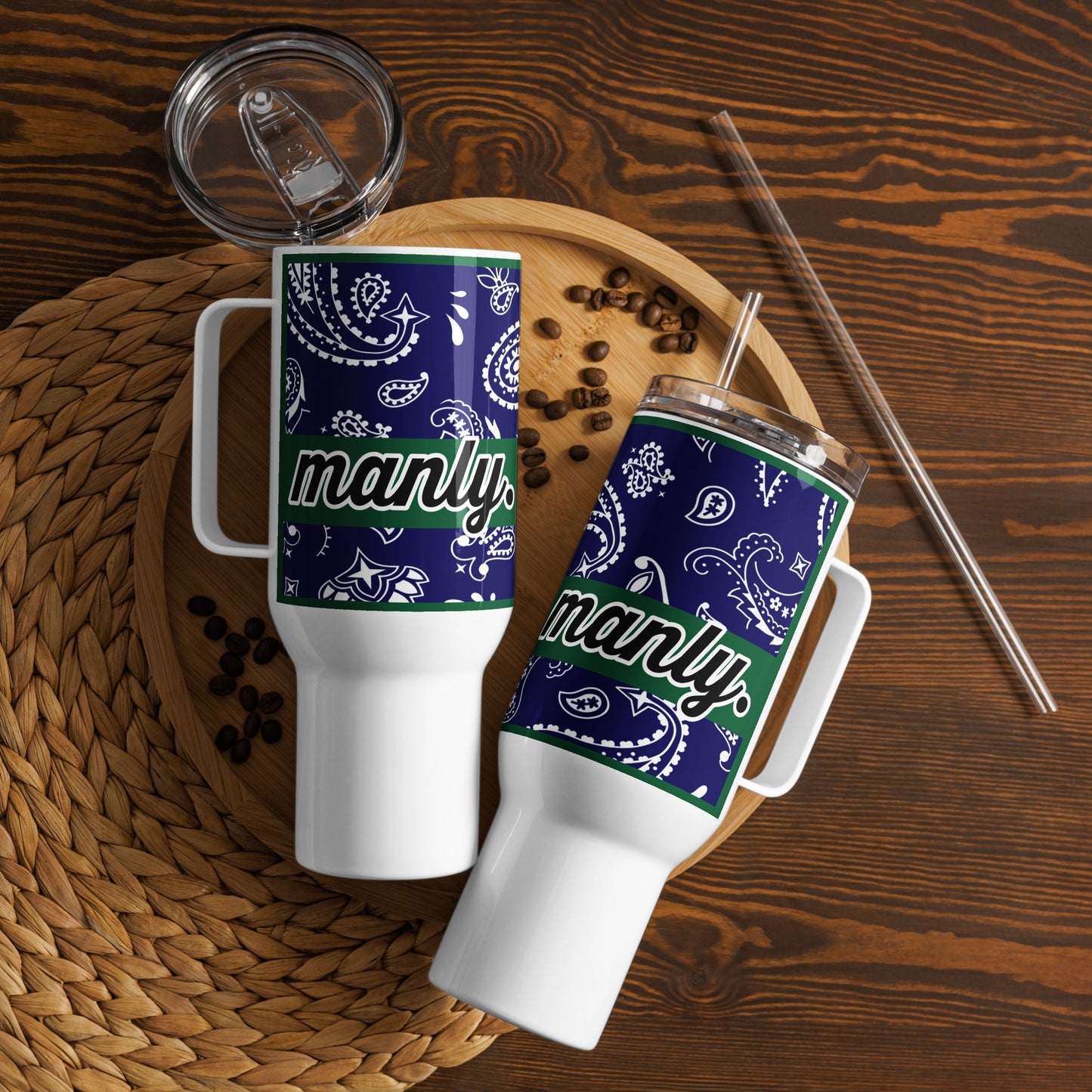 Two travel mugs with navy paisley backgrounds and word "manly' in black and green banner behind