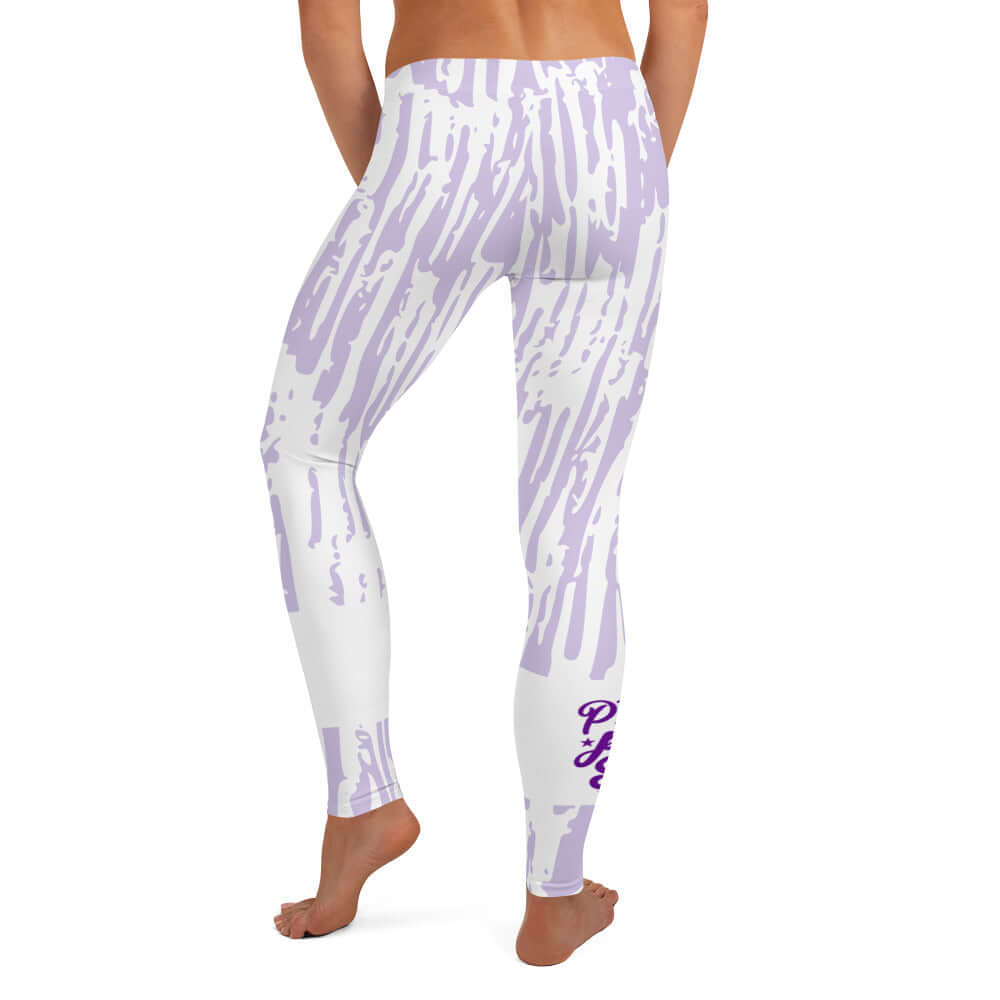 Back view of purple and white print leggings with purple text around bottom right leg saying 'Praise Pray