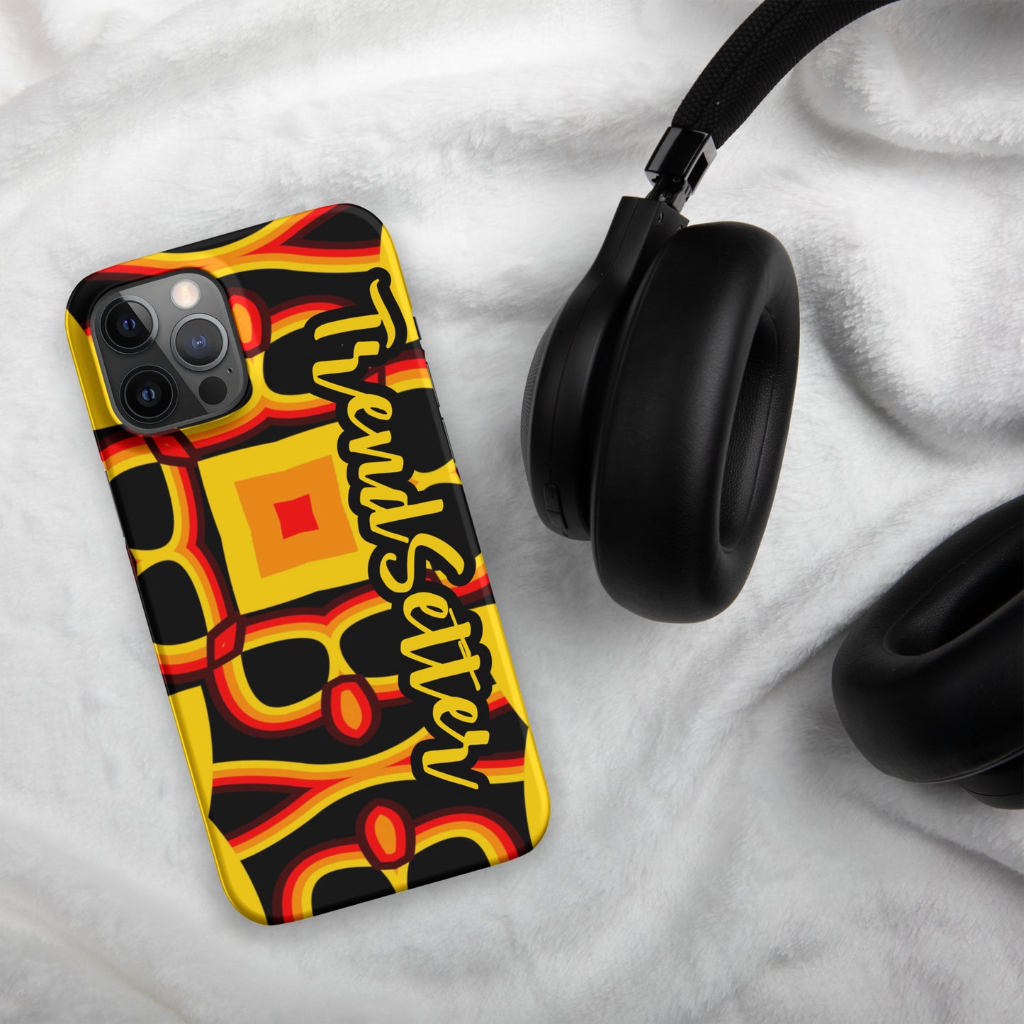 Front of gold, yellow, red and black print iPhone 12 matte case with text "TrendSetter' in black and gold