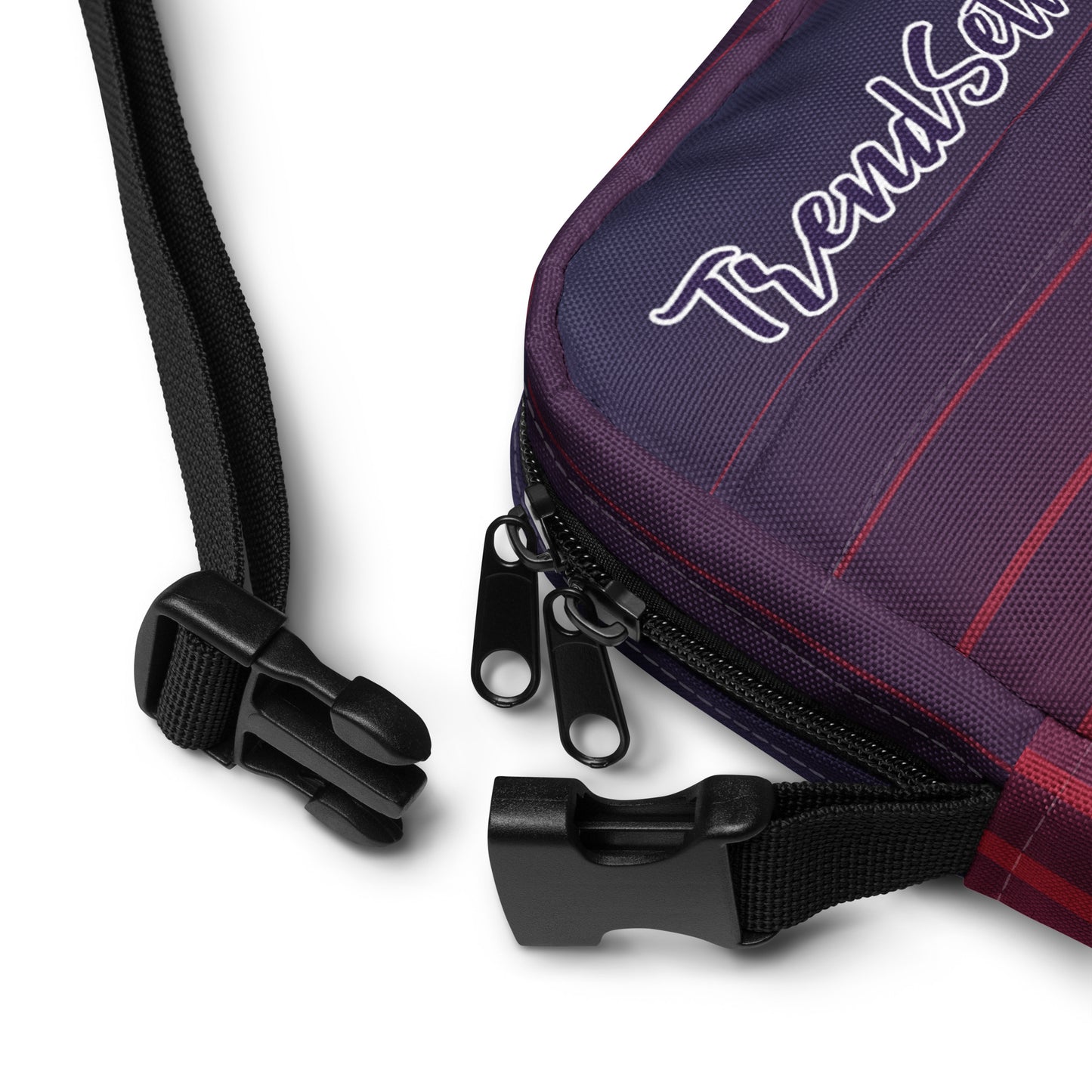 Detailed view straps of TrendSetter Utility Crossbody Bag with red and blue stripped design and with TrendSetter logo