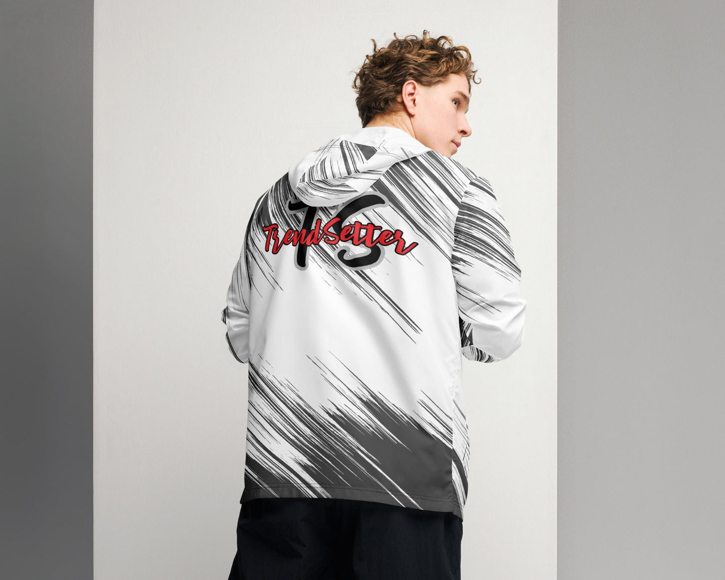 Back of a black and white windbreaker with red text saying 'TrendSetter' and black and grey text saying 'TS'