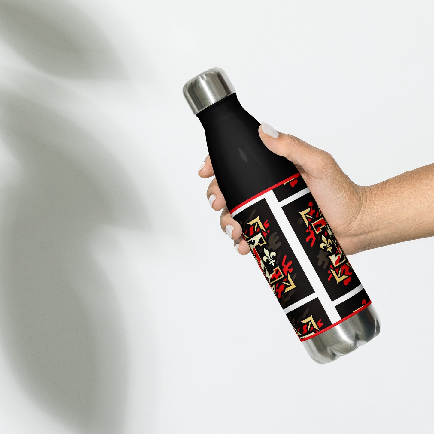 Backof black water bottle with gold red and white design with letters 'D' and 'C" as part of the design