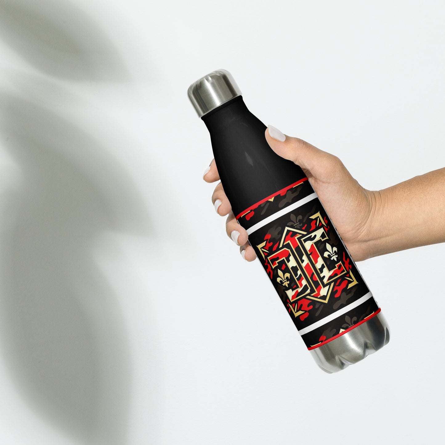 Right of black water bottle with gold red and white design with letters 'D' and 'C" as part of the design