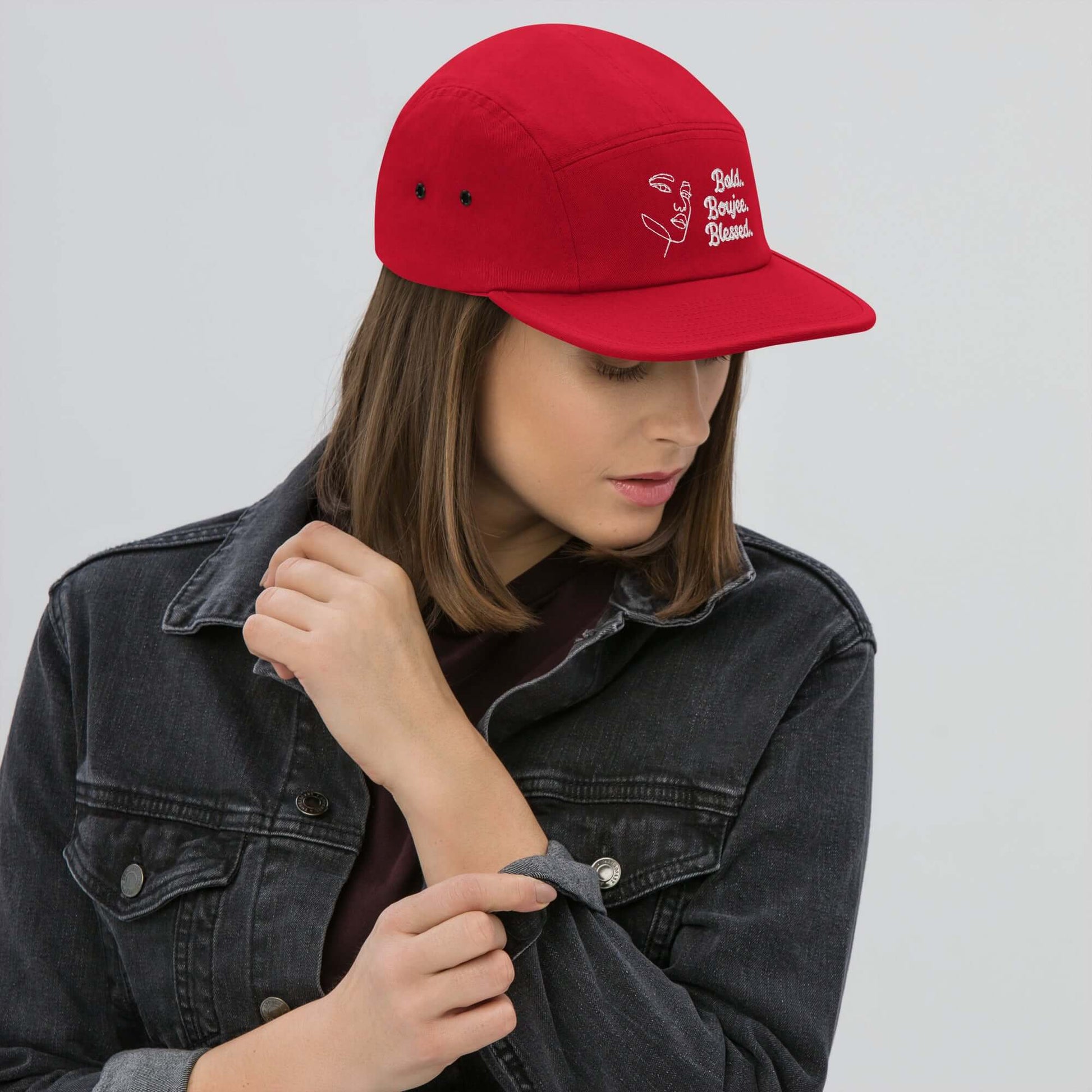 "Woman wearing a red five-panel cap with white text saying Bold, Boujee, Blessed"