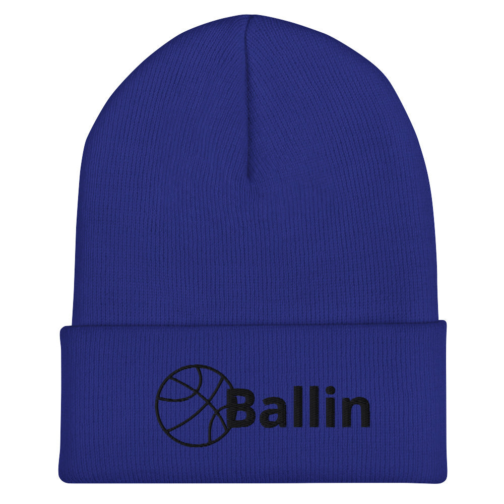 Front of royal cuffed beanie with black logo of basketball and word saying 'ballin'