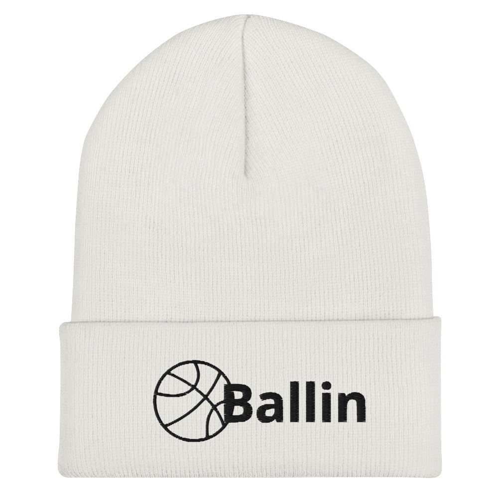 Front of white cuffed beanie with black logo of basketball and word saying 'ballin'