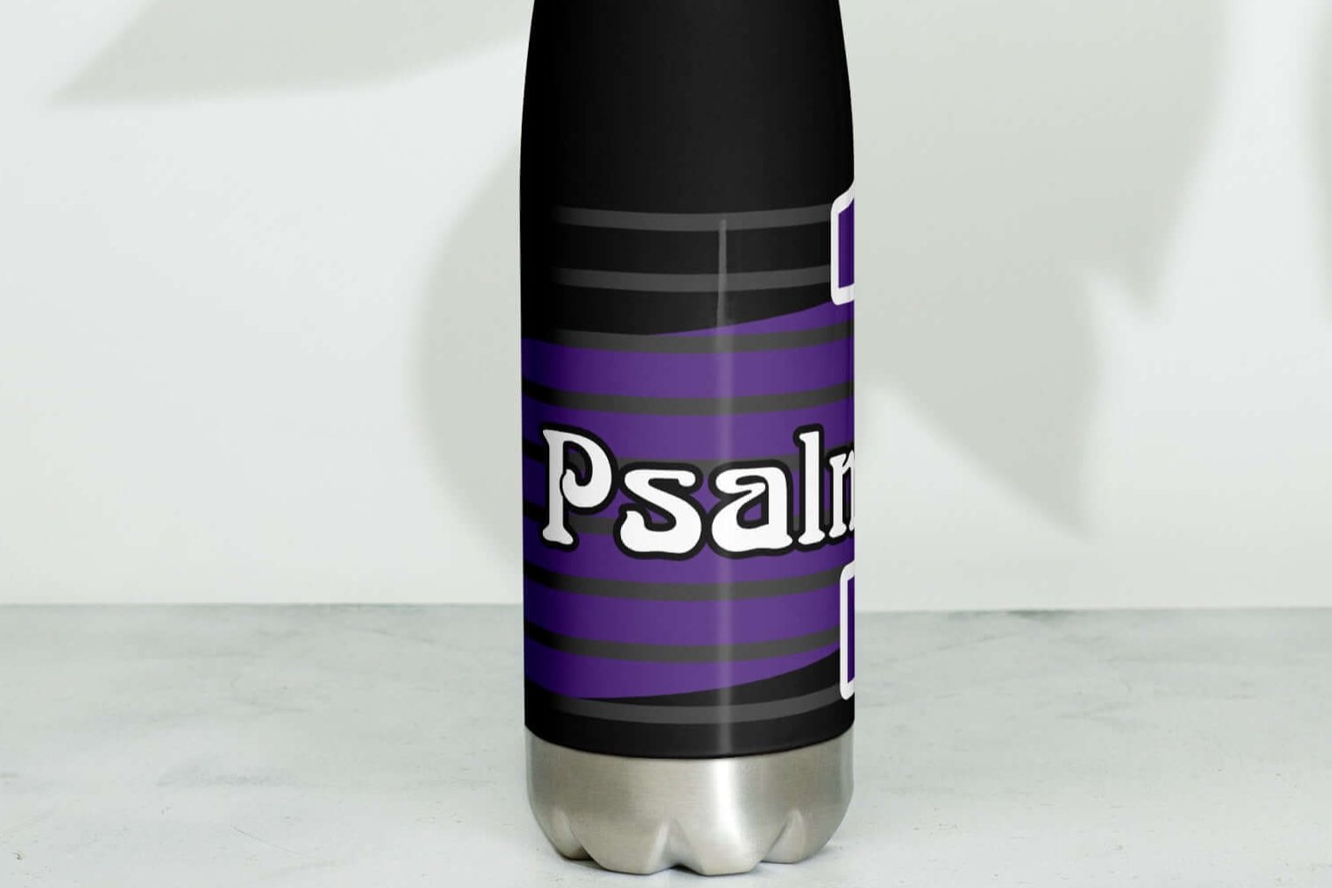 Left side of a 17 oz black stainless steel water bottle with purple and white text saying 'Psalm 1 man'