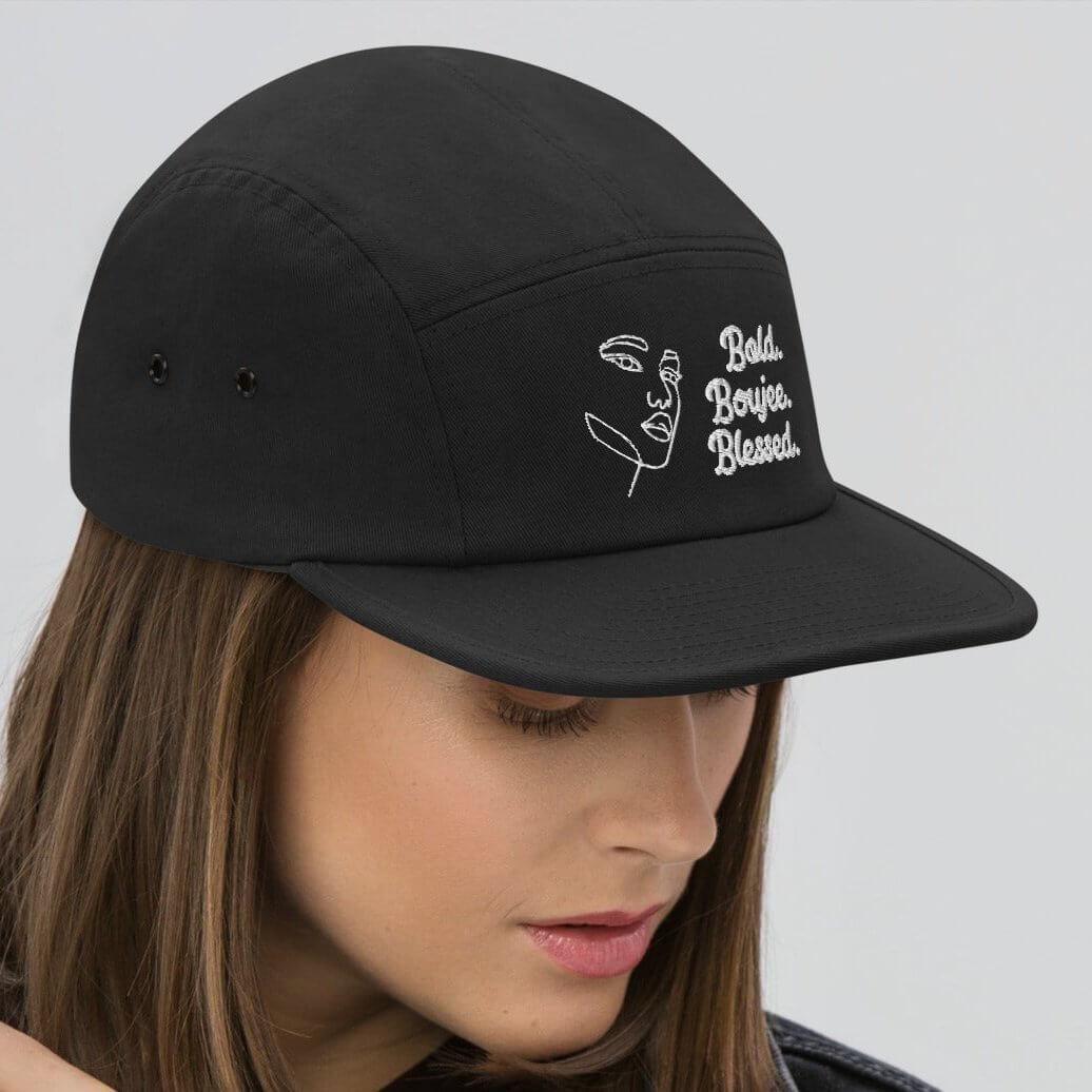 Right side of black five-panel cap with white text saying 'Bold, Boujee, Blessed'