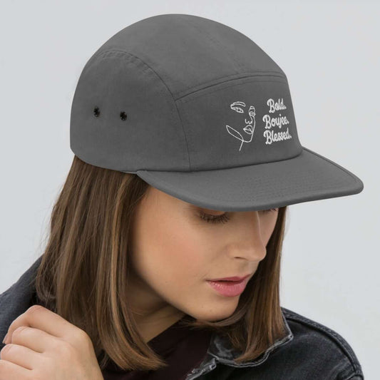 Right view of a gray five-panel cap with white text saying Bold, Boujee, Blessed"