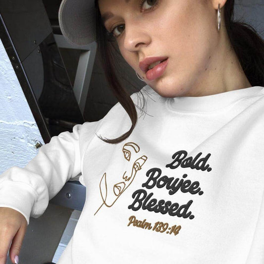 White sweatshirt with outline of a woman's face in brown, text saying 'Bold, Boujee, Blessed' in black, and 'Psalm 139:14' in brown