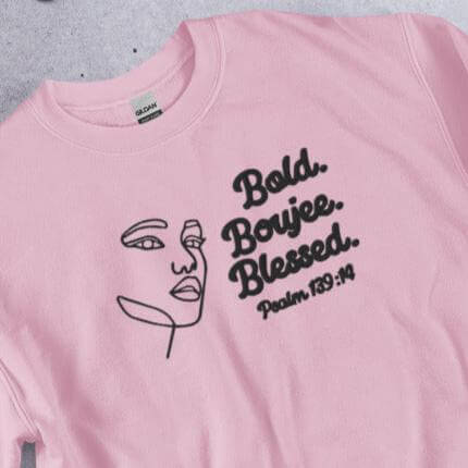 Front of pink sweatshirt with outline of a woman's face in black and text saying 'Bold, Boujee, Blessed and Psalm 139:14' in black