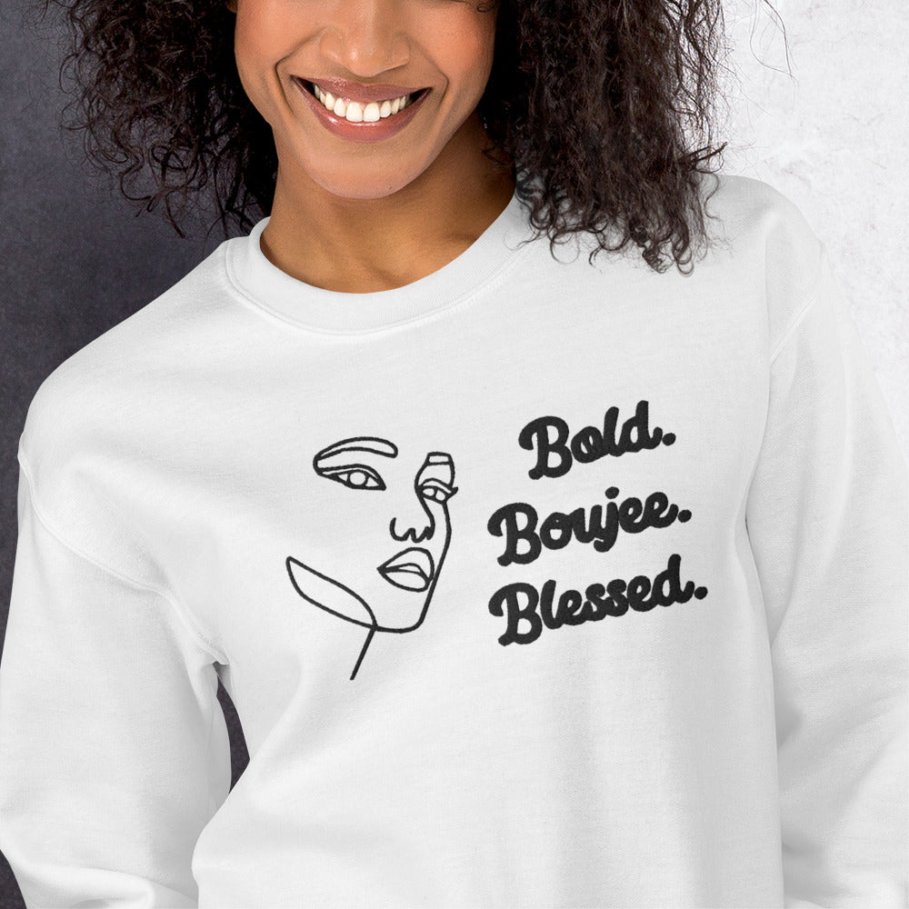 Zoomed white sweatshirt with outline of a woman's face and text saying 'Bold, Boujee, Blessed' in black