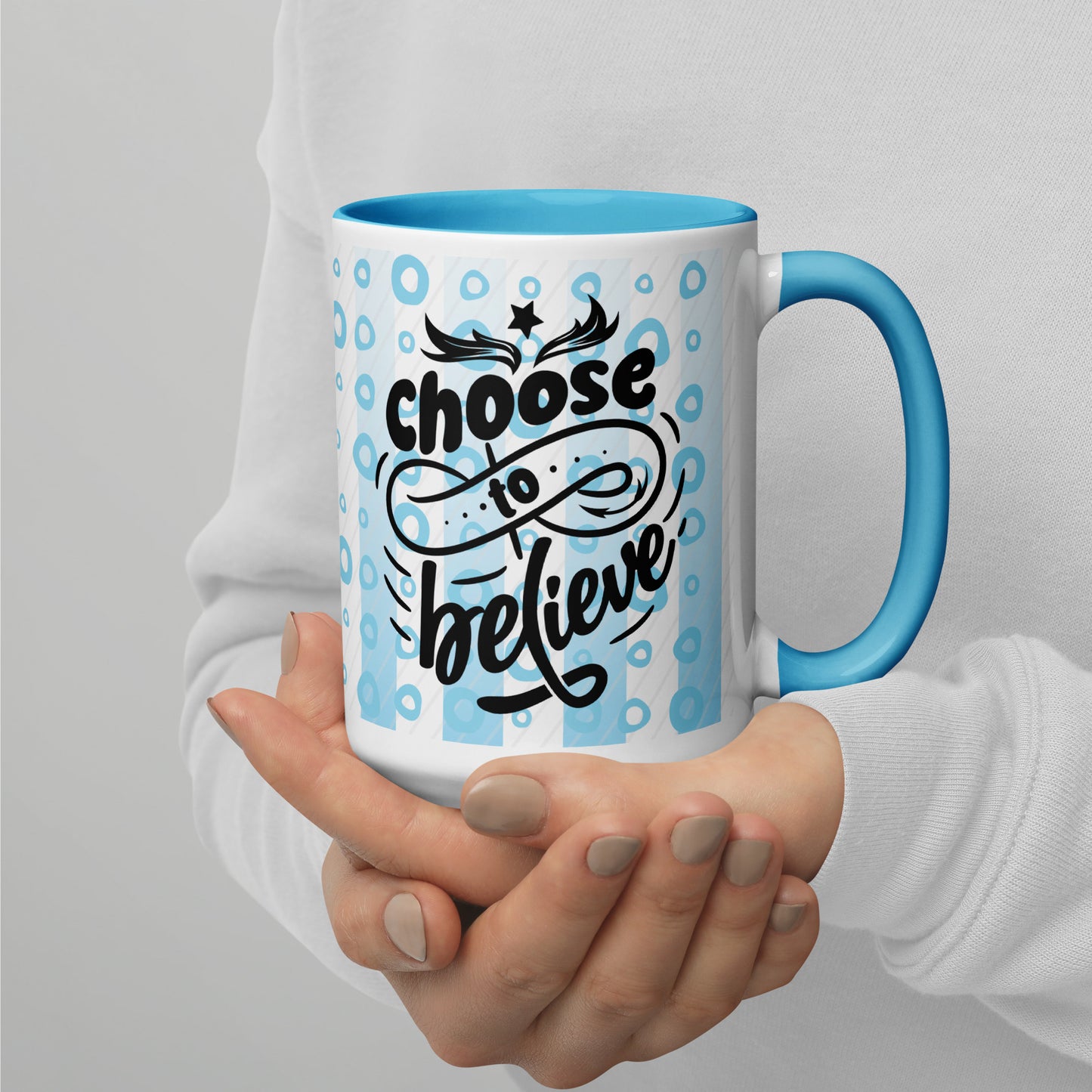 Right view of a 15 oz mug with light blue inside, outside is light blue lines and circle background, and black text saying 'choose to believe'