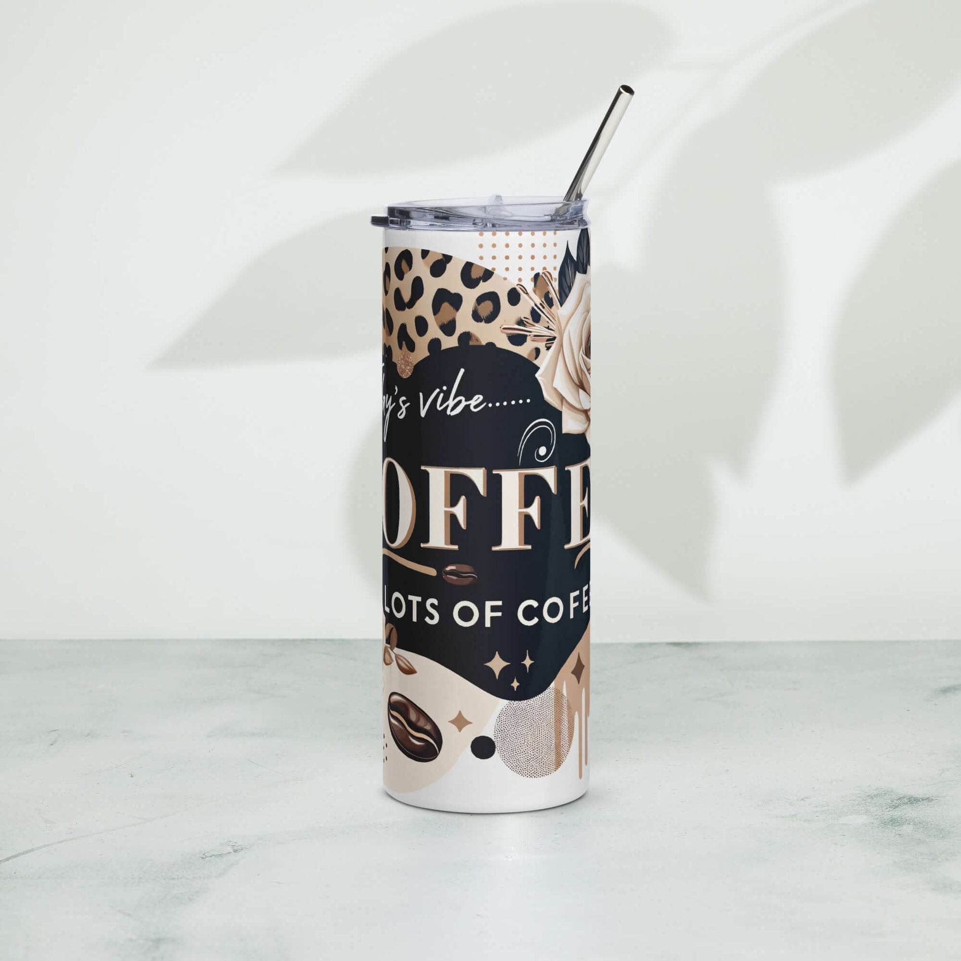 Front view of stainless steel tumbler with black, brown, beige abstract design and beige text saying 'Today's vibe, coffee, Lots of coffee'