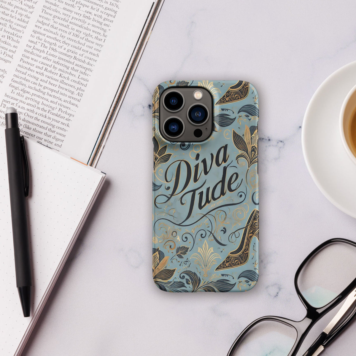 Front of blue pattern iPhone 13 pro case with text saying 'DivaTude'