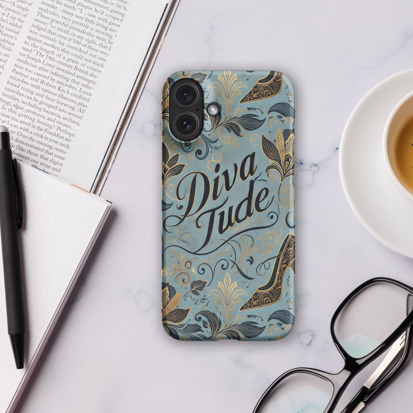 Front of blue pattern iPhone 16 plus case with text saying 'DivaTude'