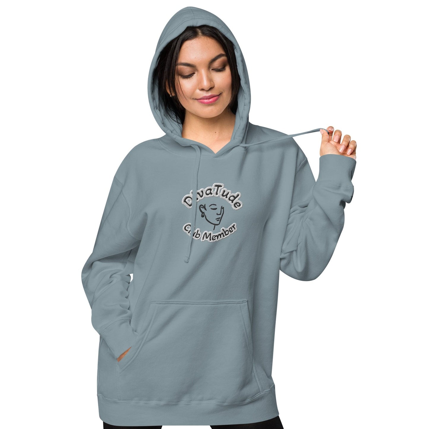 Front of slate blue hoodie with embroidered image of woman's face and text reading 'DivaTude' above and 'Club Member