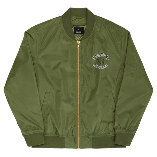 Front of army green bomber jacket with image on top left of embroidered lady's face in black with grey and black text saying "DivaTude' above and 'Club Member' below 