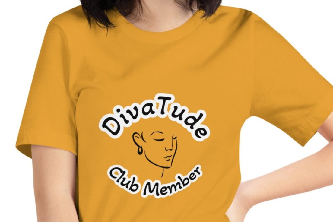 Front of mustard women's tshirt with image of lady's face in black with white and black text saying "DivaTude' above and 'Club Member' below 