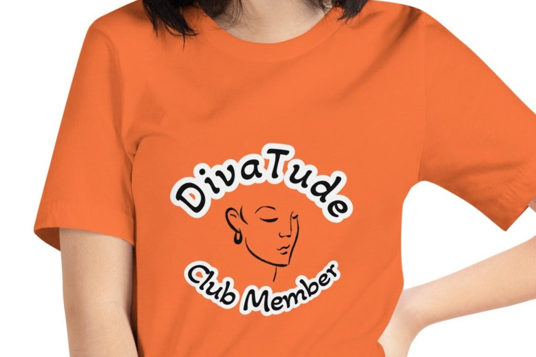 Front of orange women's tshirt with image of lady's face in black with white and black text saying "DivaTude' above and 'Club Member' below 