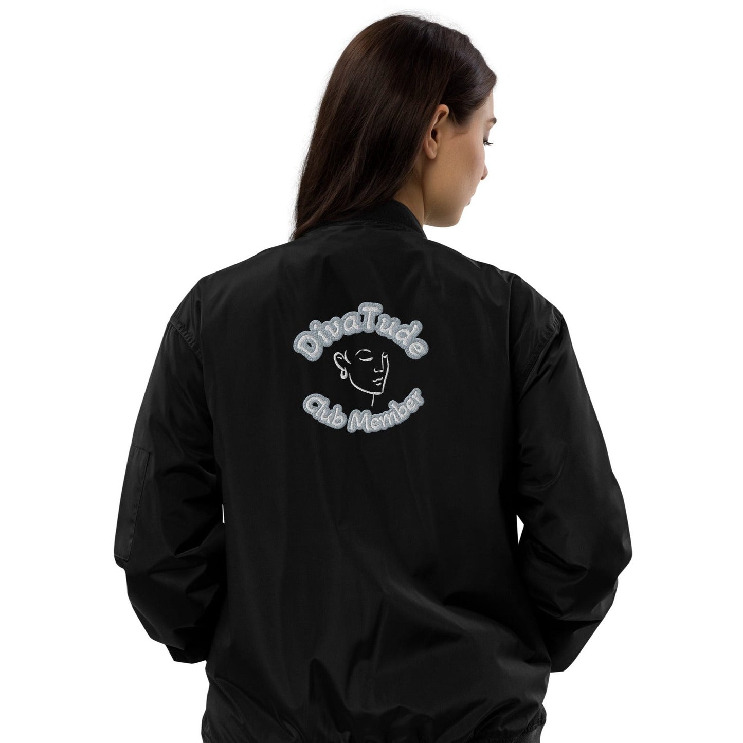 Back of black bomber jacket with image of embroidered lady's face in white and grey and black text saying "DivaTude' above and 'Club Member' below 