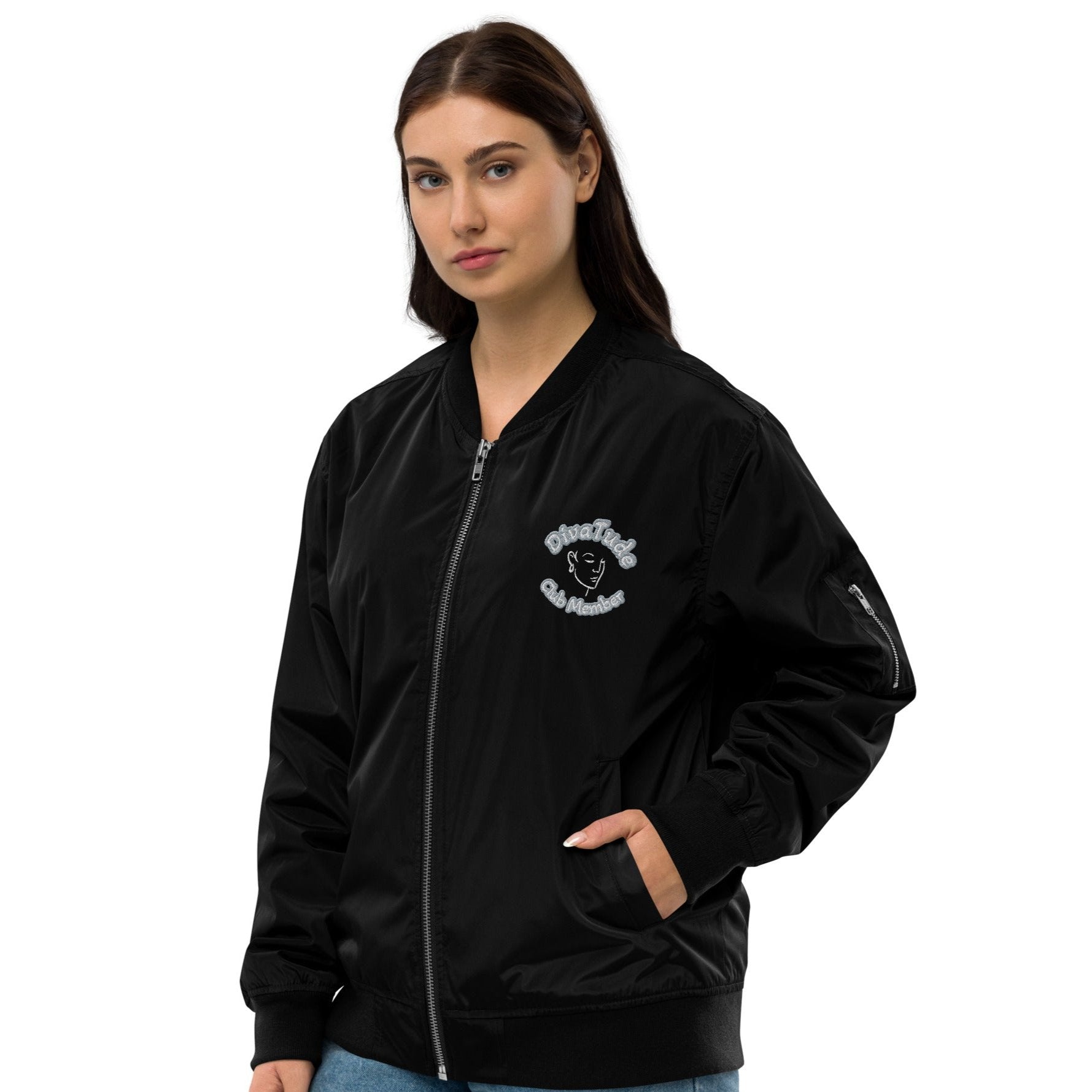 Left front of black bomber jacket with image on top left of embroidered lady's face in white and grey and black text saying "DivaTude' above and 'Club Member' below 