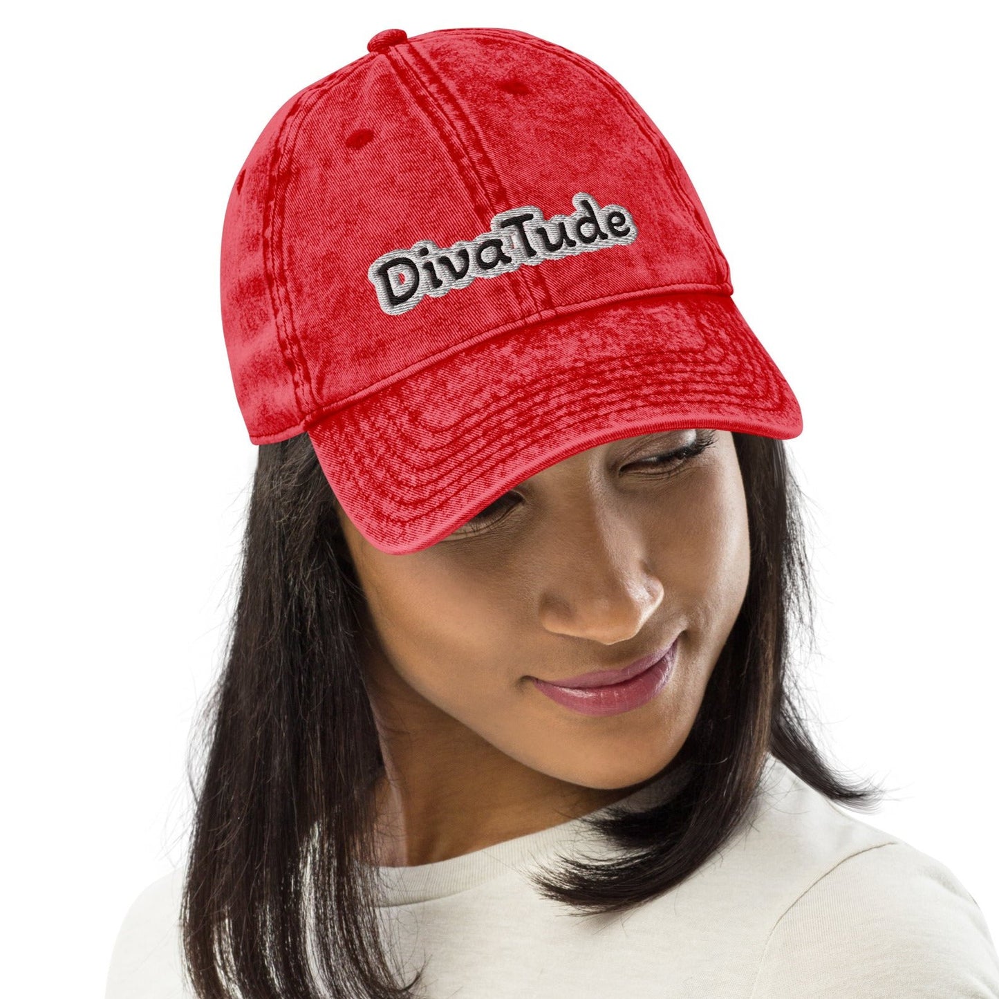 Front of maroon snap-back cap with embroidered black and gray text saying 'DivaTude' across front