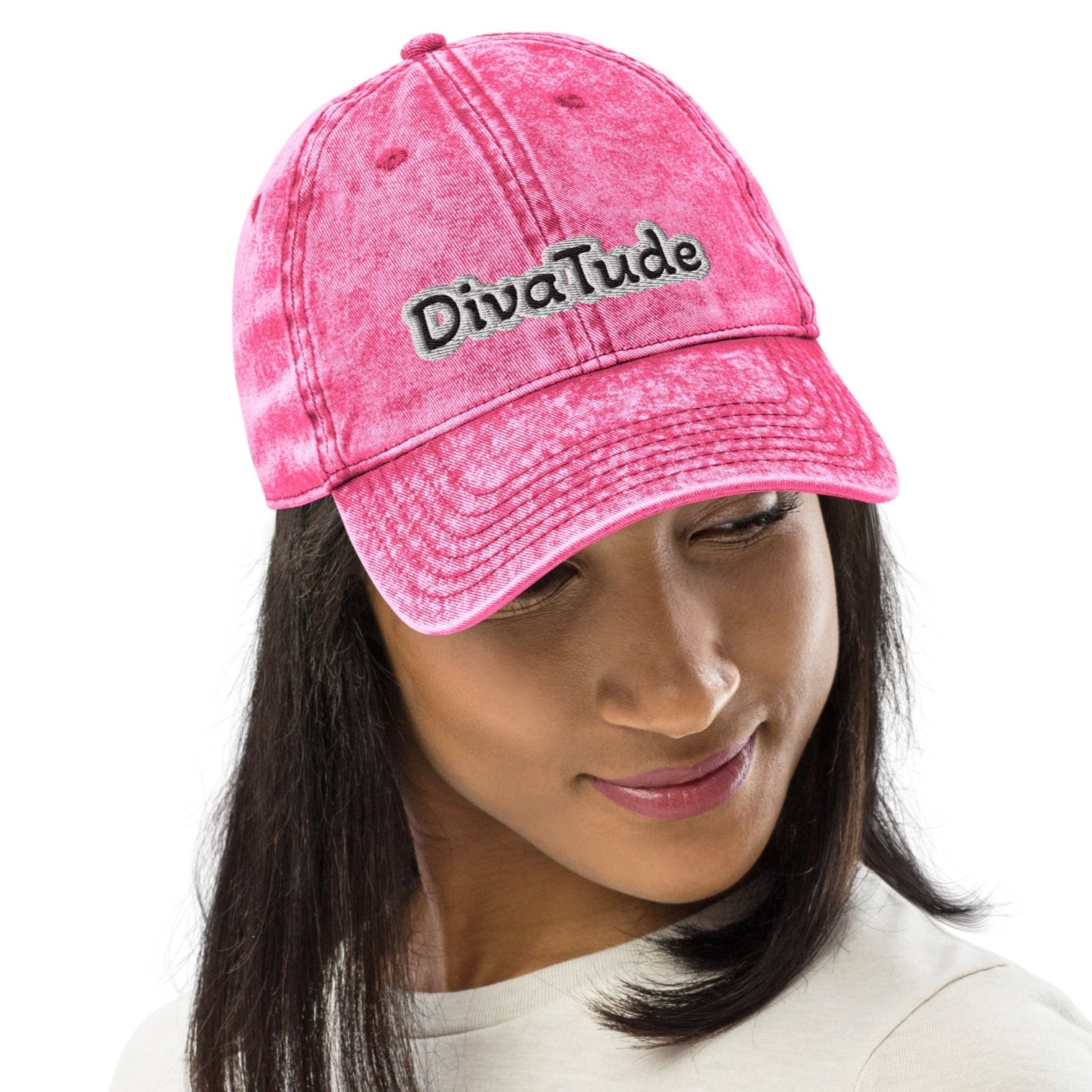 Front of pink snap-back cap with embroidered black and gray text saying 'DivaTude' across front