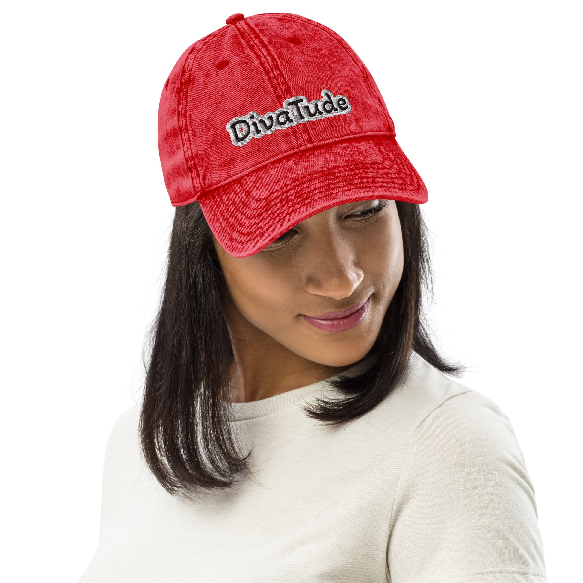 Front of red snap-back cap with embroidered black and gray text saying 'DivaTude' across front