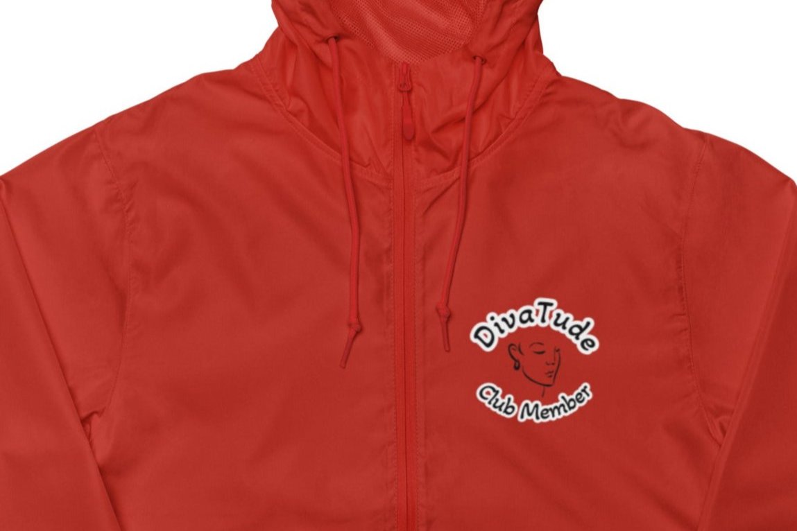 Front of women's red windbreaker with image on top left of embroidered lady's face in black with grey and black text saying "DivaTude' above and 'Club Member' below 