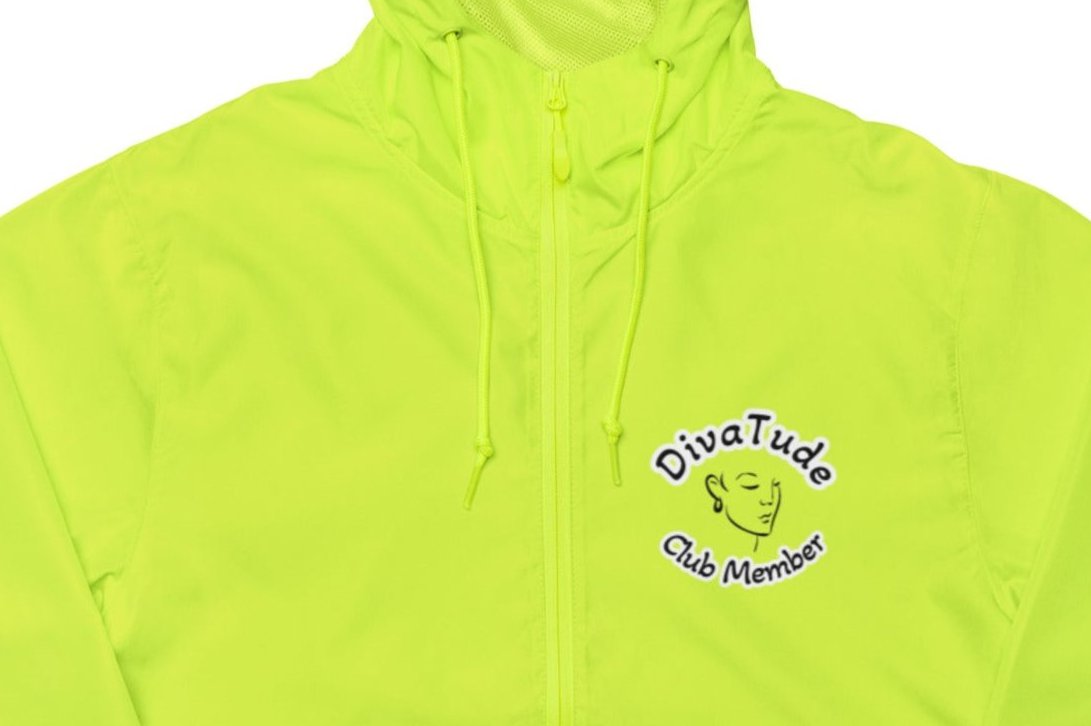 Front of women's yellow windbreaker with image on top left of embroidered lady's face in black with grey and black text saying "DivaTude' above and 'Club Member' below 