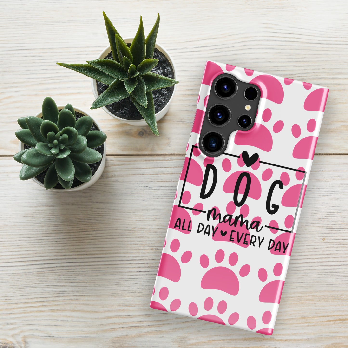 Front of Samsung snap case with a white and pink paw background and black text saying 'Dog Mama All Day Every Day'