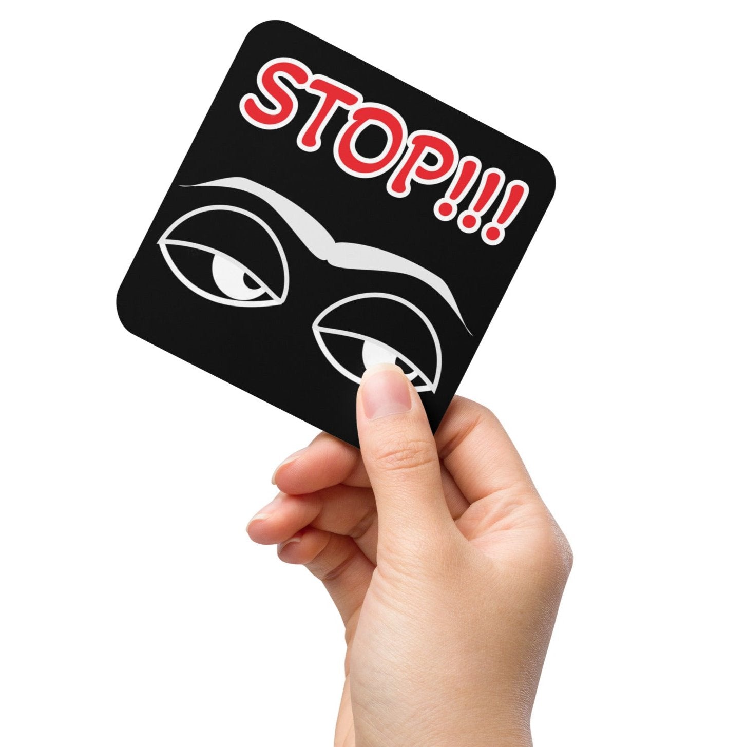 Cork back coaster with a black background and red and white text saying 'Stop!!!' on top and white eyes and eyebrows image on bottom