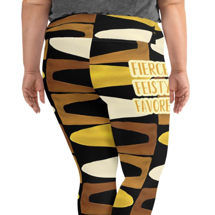 Back view of a woman wearing black, brown, beige and gold print leggings with gold and white text saying 'Fierce.Feisty.Favored.' on right hip 