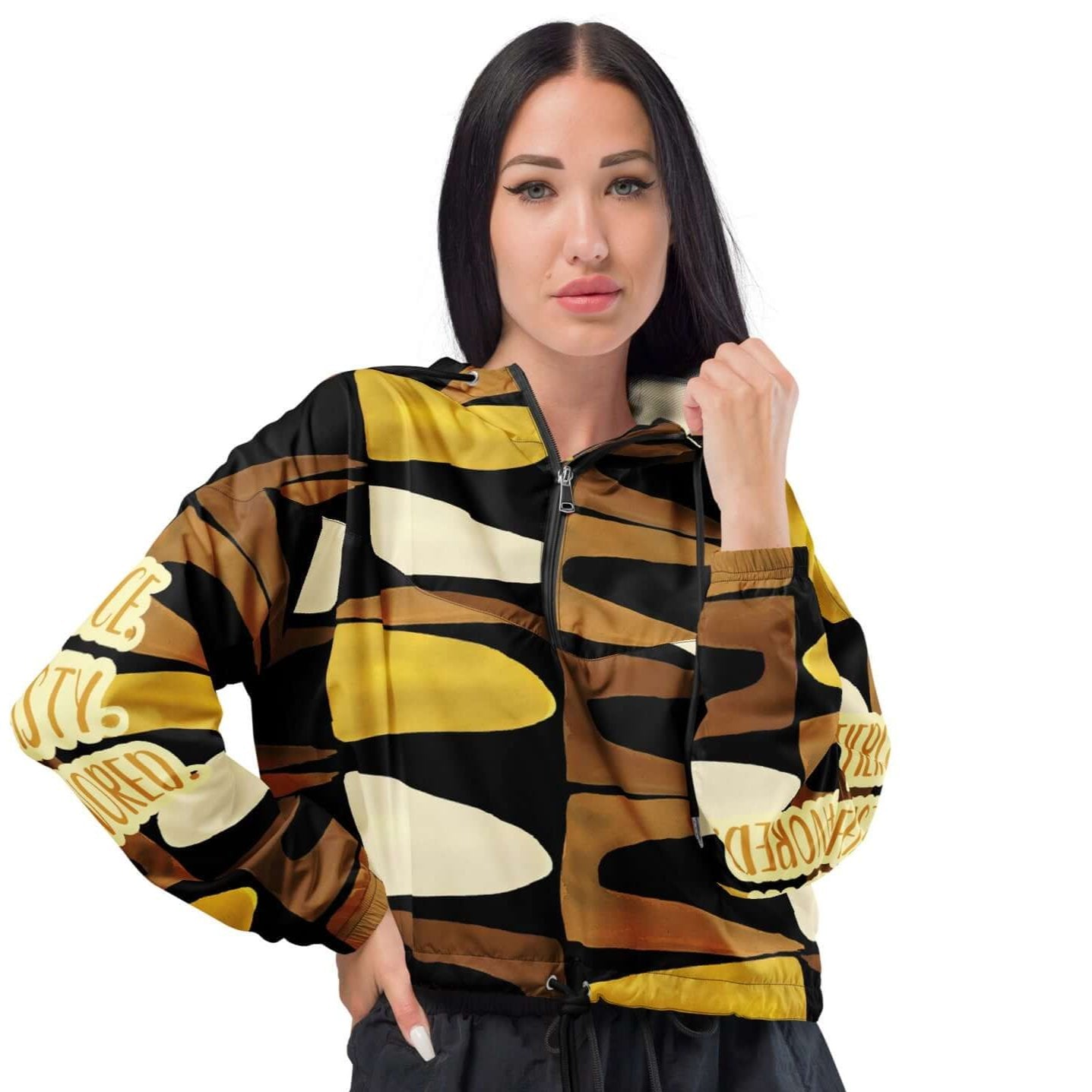 Front view of a cropped black, brown, beige and gold print windbreaker with gold and white text saying 'Fierce.Feisty.Favored.' on the right and left sleeves