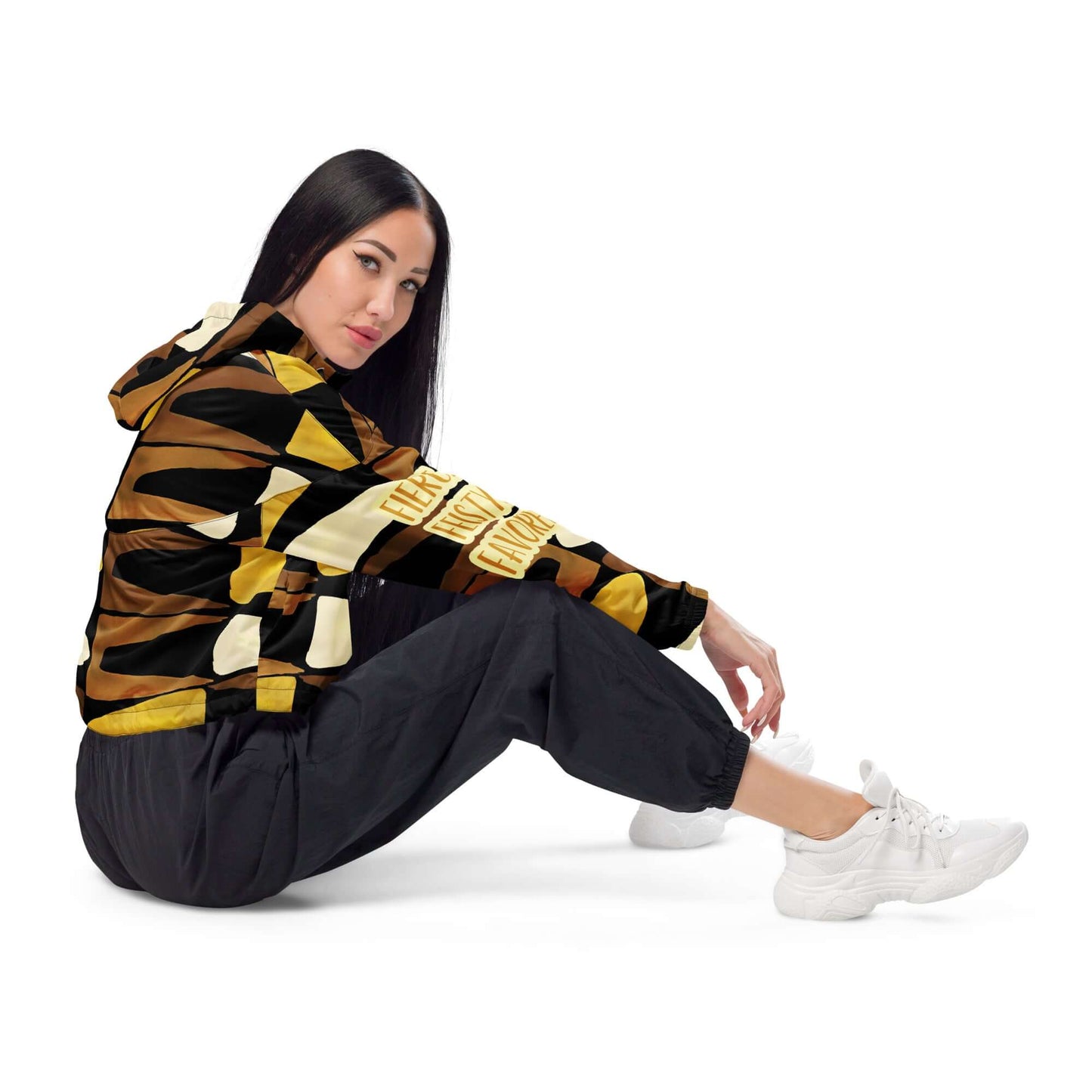 Right side view of a cropped black, brown, beige and gold print windbreaker with gold and white text saying 'Fierce.Feisty.Favored.' on the right sleeve