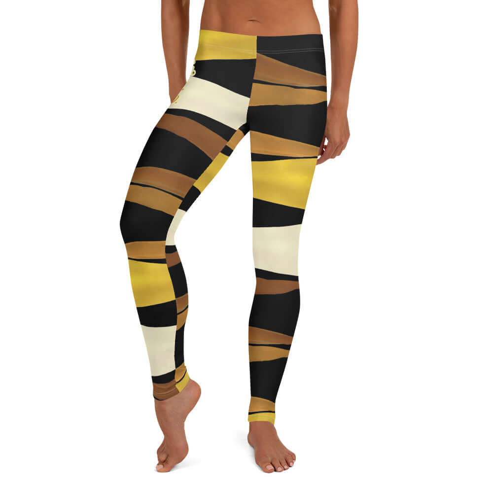 Front view of black, brown, beige and gold print leggings