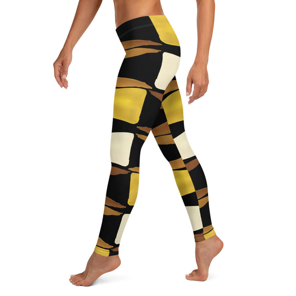 Left-side view of black, brown, beige and gold print leggings