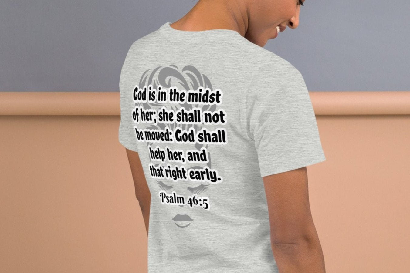 Back of heather t-shirt with grey image of woman's face underneath Psalm 46:3 scripture