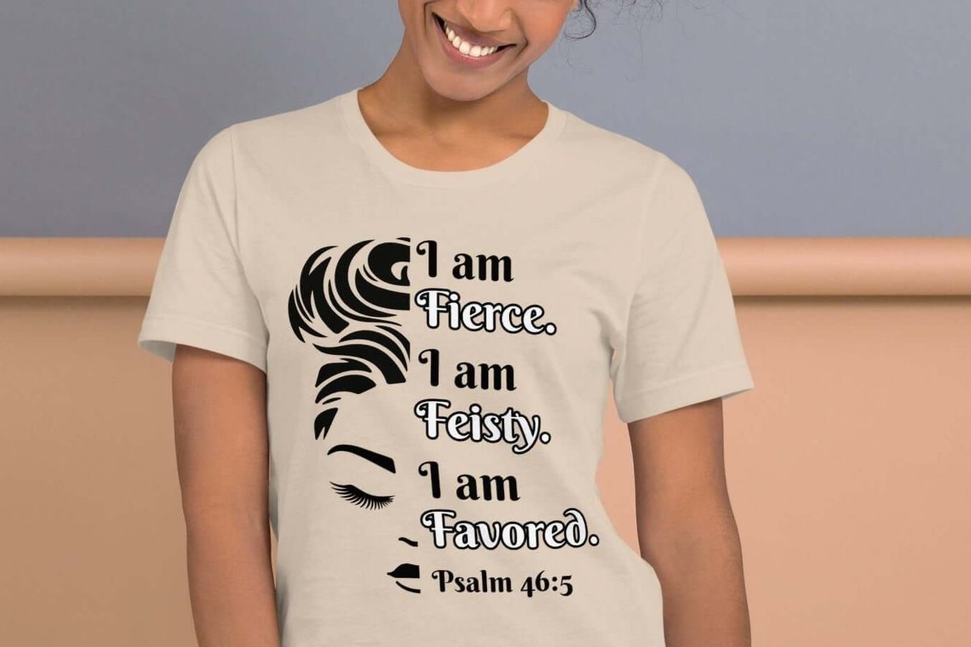 Front of soft cream t-shirt with image of half woman's face with black and white text saying "I am fierce, I am feisty, I am favored and Psalm 46:3'