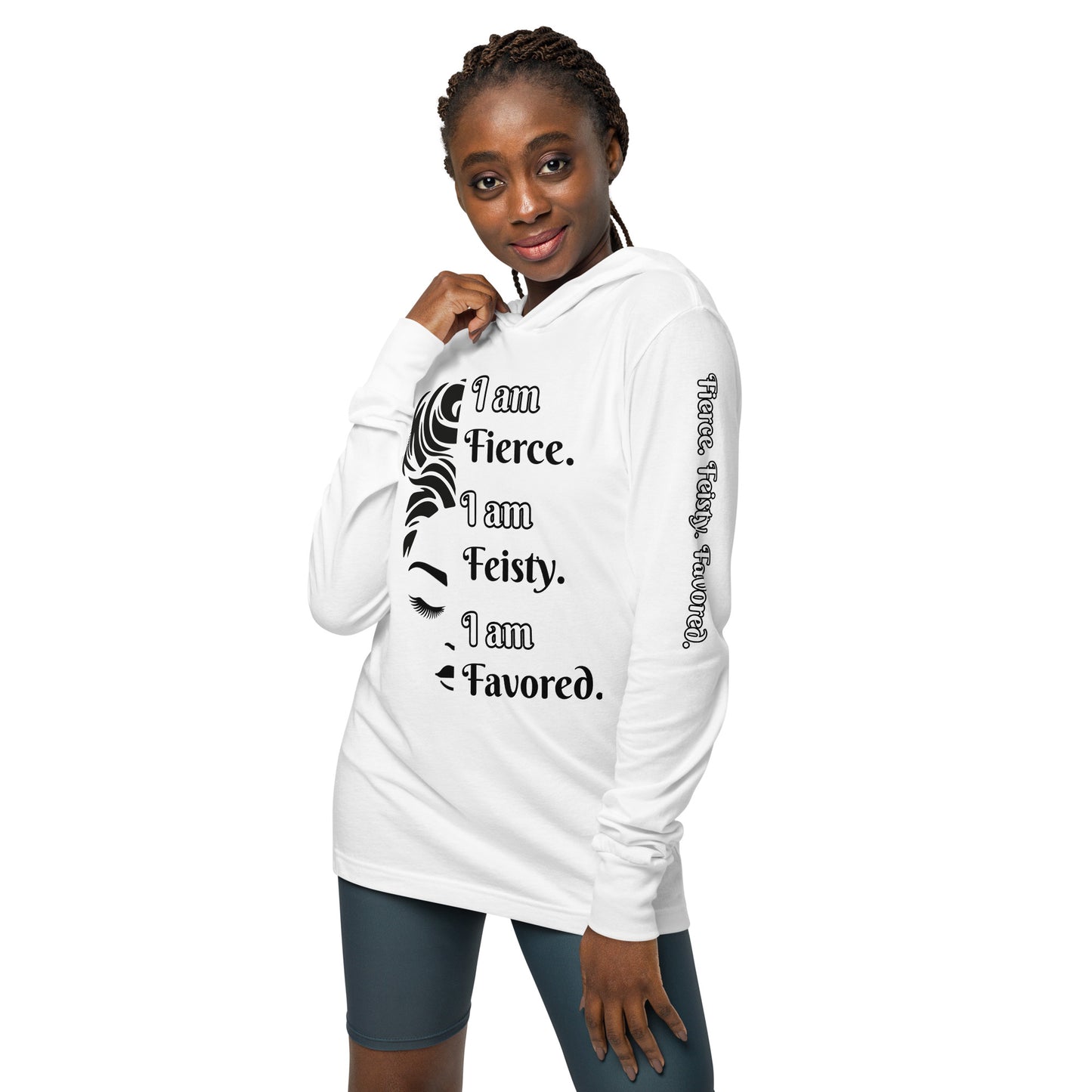 Front of white hooded long sleeve tee with black image of 1/2 woman face and black and white text saying 'I am fierce. I am feisty. I am favored.'