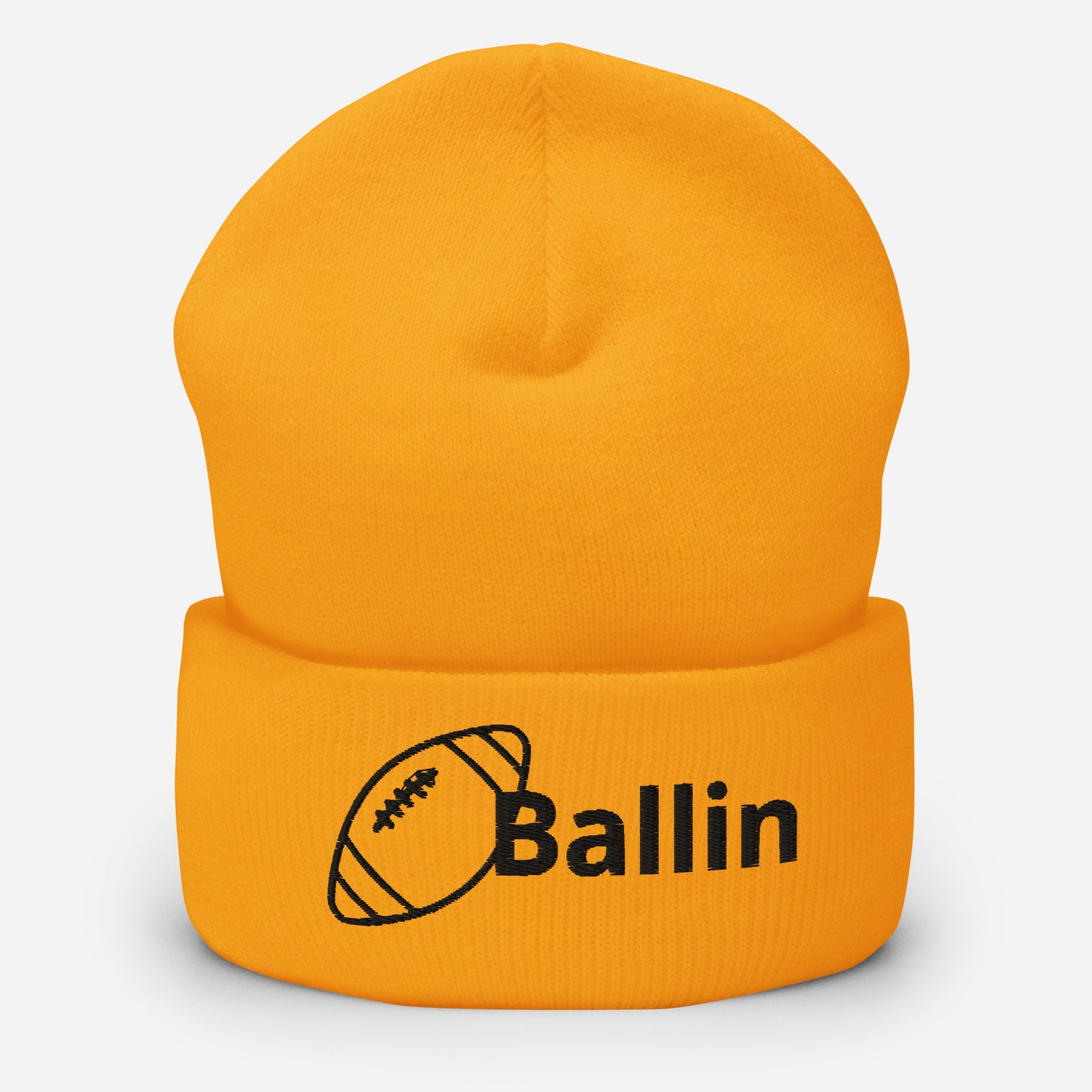 Front of gold cuffed beanie embroidered with a black football and black text saying 'ballin'